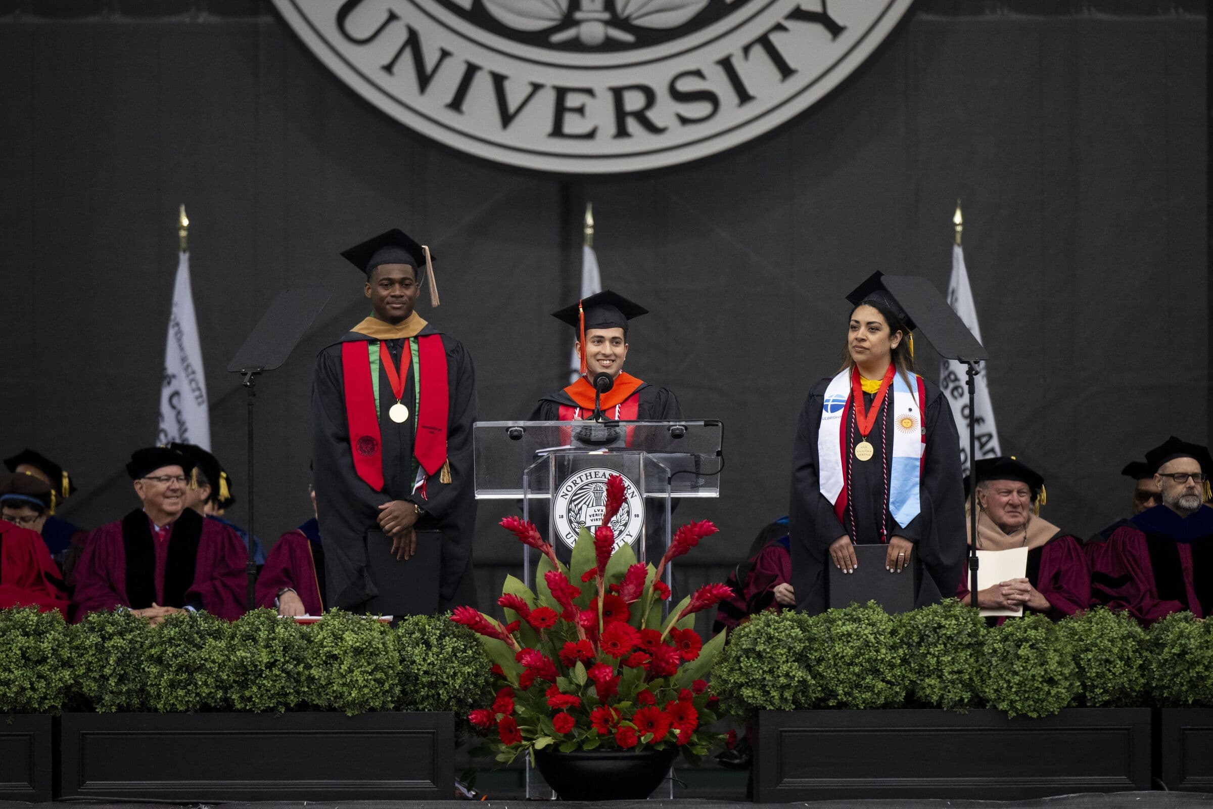 Shayan Menahi on stage with fellow honorees at Northeastern University commencement