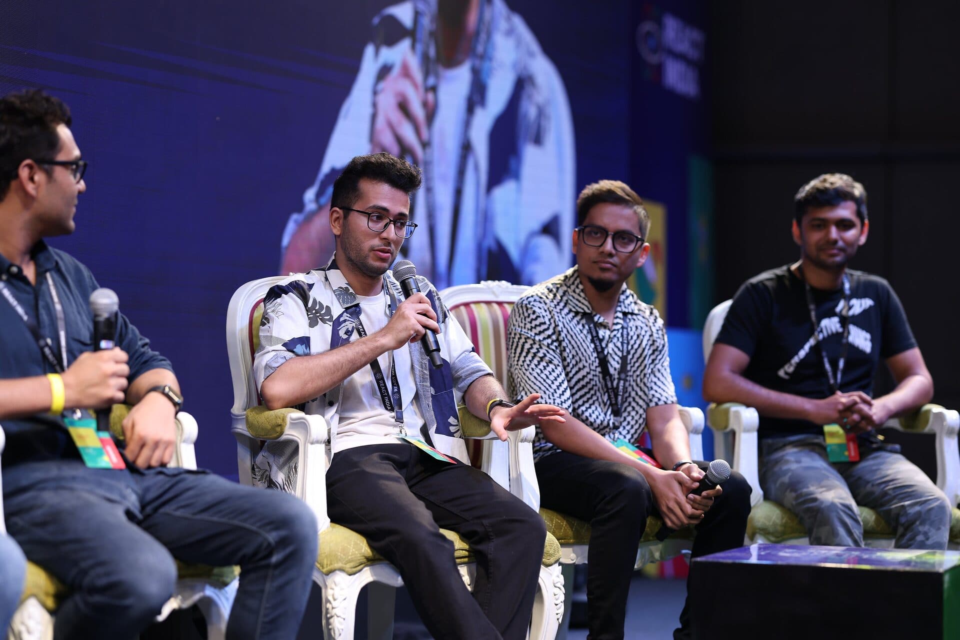 Shayan Menahi speaking on stage at React India 2023 in Goa